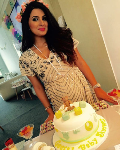 Geeta Basra poses with cake at her baby shower