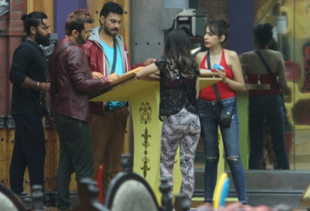 Bigg Boss participants check the rule book