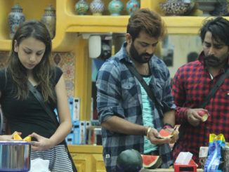 Contestants cook a meal in the house