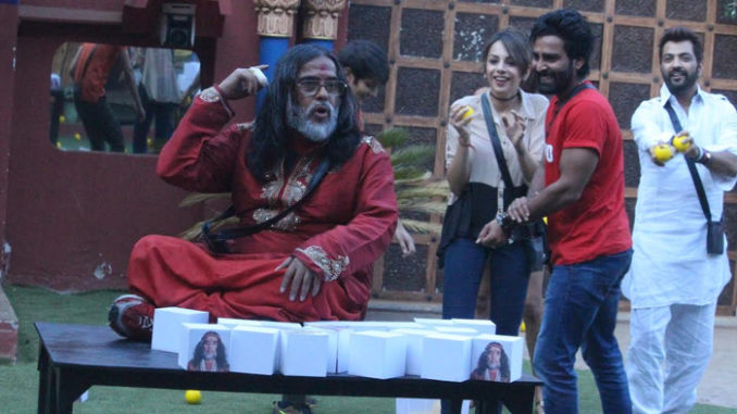 Om Swami parks himself on the table during the captaincy task
